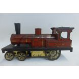 An early clockwork tinplate model of a steam locomotive, possibly German.