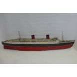 A good quality part tinplate scale model of the Queen Elizabeth ocean liner.