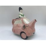 A crackle glazed pottery teapot in the form of a bubble car.
