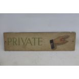 A wooden sign - Private, with directional hand pointing right, 20 1/2 x 5 1/2".