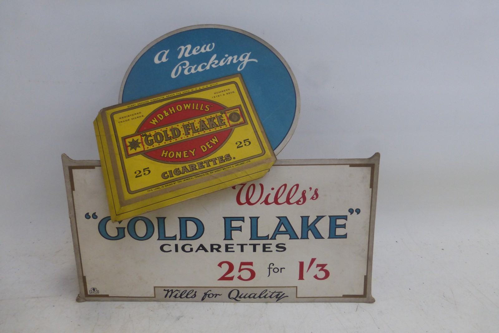 A Wills's 'Gold Flake' die-cut showcard, 8 3/4 x 8 1/2".