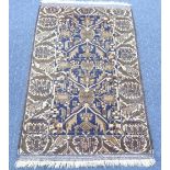 Tribal Rugs; a blue, cream and taupe Persian Rug, the whole woven with stylized geometric