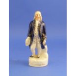 A Staffordshire Pottery figure of George Washington, standing, decorated in colours on gilt titled