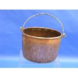 A 19thC large copper Cauldron, with heavy brass lugs and rivets holding the iron swing handle,