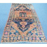 Tribal Rugs; a blue and pale red ground Persian Rug the whole woven with stylized geometric