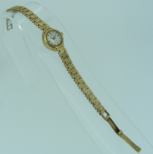 A 9ct yellow gold ladies Rotary Wristwatch, with white enamel and gold dial, on a flexible 9ct