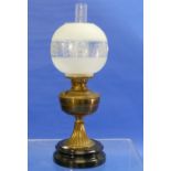 A Victorian brass Oil Lamp, with frosted and etched spherical shade, on a black circular base,