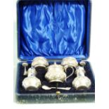 An Edwardian silver cased five piece Cruet Set, by Joseph Gloster, hallmarked Birmingham 1904,