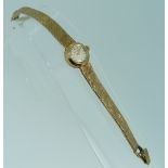 A 9ct gold Omega lady's Wristwatch, with Swiss movement and integral 9ct gold flexible textured