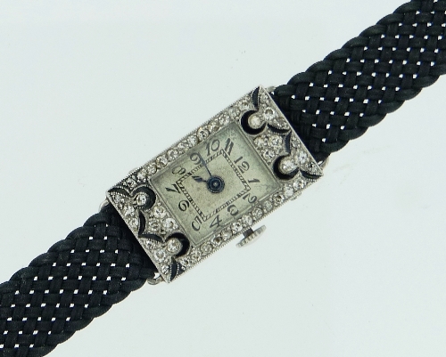 A French platinum and diamond lady's Cocktail Watch, of rectangular form, the silvered dial with