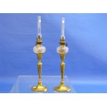 A pair of early 19thC brass candlestick Oil Lamps, each with a small cut glass spherical