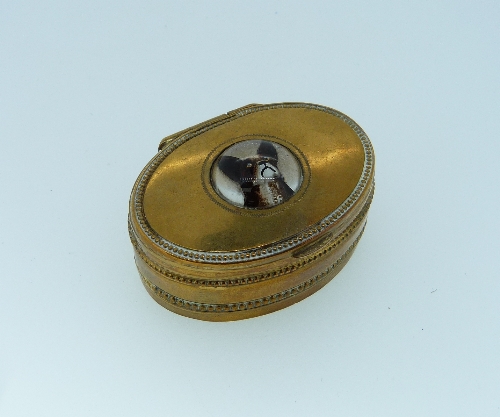 An Essex Crystal reverse painted Intaglio, of a French Bulldog, set in the lid of an oval gilt metal