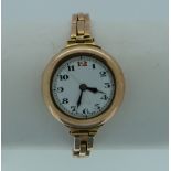 A 9ct gold lady's Wristwatch, with circular dial and 9ct gold expanding gate-link bracelet.