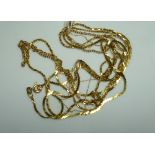 A 14k yellow gold fine trace Chain, together with another 14k yellow gold trace chain and two 9ct