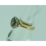 A diamond cluster Ring, the shank in 18ct yellow gold, Size K.