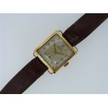 An 18ct gold Nimra gentleman's Wristwatch, c.1925, with 15 jewels movement, the square silvered dial