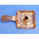 A Newlyn style Arts & Crafts copper Candle-holder, embossed with fish, with old repair to handle,