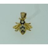 A yellow metal Pendant, formed of a Bee, the body and head set with small sapphires and diamonds,
