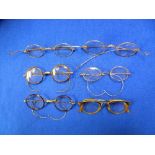 A collection of six pairs of Spectacles, including two pairs of gilt metal framed Wig Spectacles,