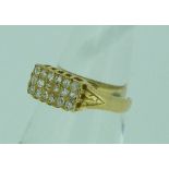 An 18ct yellow gold Ring. the rectangular front set with three rows of six small diamonds, Size L.