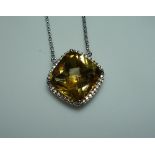 A square facetted citrine Pendant, mounted in 18k white gold, formed into a caged back, and with a