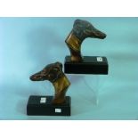 A pair of Art Deco style bronzed spelter Greyhound-head Bookends, on ebonised wood plinths, 8½in (