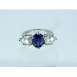 A three stone sapphire and diamond Ring, the central oval sapphire, circa 2cts, with a tear drop