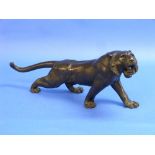 A Japanese bronze figure of a Tiger, Meiji period, modelled in a roaring pose, signed, 21in (53.