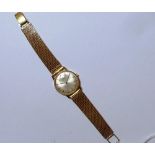 An Omega gold-plated lady's Wristwatch, with silvered circular dial, on a 9ct gold flexible