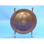 An Arts & Crafts copper-coloured metal Fire Screen, of concave circular shield-shaped form, 23in (