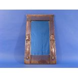 An Arts and Crafts Liberty & Co copper Mirror, of upright tapering rectangular form, the frame