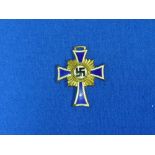 A W.W.2 period German "DER DEUTSCHEN MUTTER" Cross, with blue enamel and gold coloured metal, the