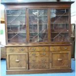 An Edwardian mahogany glazed Bookcase, the base with three frieze drawers above three central