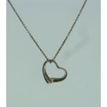 A Tiffany & Co., silver open heart Pendant, on a silver trace chain.