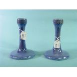 A pair of Ruskin pottery Candlesticks, with lustrous mottled light blue glazes, each with a circular