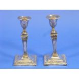 A pair of Edwardian silver Candlesticks, hallmarked London, 1901, on a square base, tapering stem