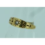 A small 18ct yellow gold Ring, gypsy set in the centre with small diamond point, Size M.