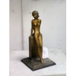 A French Art Deco spelter figural Table Lighter, modelled as a female nude leaning against a plinth,