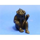 A Japanese bronze figure of a Monkey, Meiji period, in seated pose, signed, 4½in (11.25cm) high.