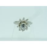 An attractive diamond Dress Ring, the centre with brilliant cut diamond, c. 0.7ct, surrounded by ten