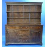 A George III enclosed oak Dresser and Plate Rack, the base with three frieze drawers above three