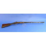 A 19thC French double barrelled percussion shot gun, in poor condition, but with ornately carved