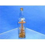 A 19thC wooden cross in a glass bottle, possibly by Napoleonic prisoner of war, 12in (30.5cm) high.