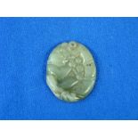 An Chinese oval carved Jade Pendant, of pale green through to yellow tones, the front carved with