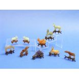 A set of ten oriental carved and polished stone Animals, of small size with carved wood stands,