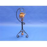 A Christopher Dresser style copper Kettle on wrought iron Stand, 34in (87cm) high.