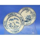 A Chinese porcelain blue and white Dish, painted with flowering shrubs, 12?in (31.5cm) diameter, and