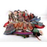 A collection of Chinese dolls in traditional costume, sold with slippers and shoes., a pair of