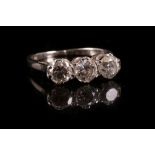 A diamond three stone ring c.1930, set with three uniform sized brilliant cut diamonds, claw set