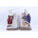 A pair of 19th Century French porcelain figures of medieval ladies sitting by fountains, both